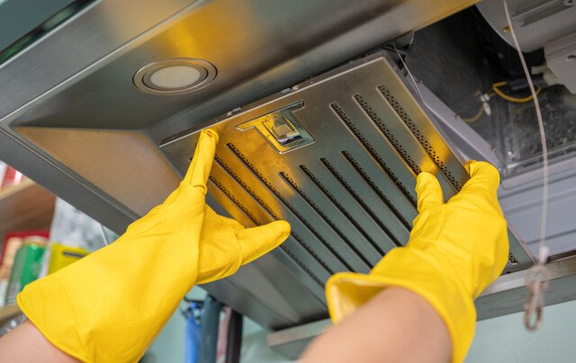 Is Your Kitchen Hood Filter Causing Food Odors ? Kitchen hood above a stove in a modern UAE apartment
