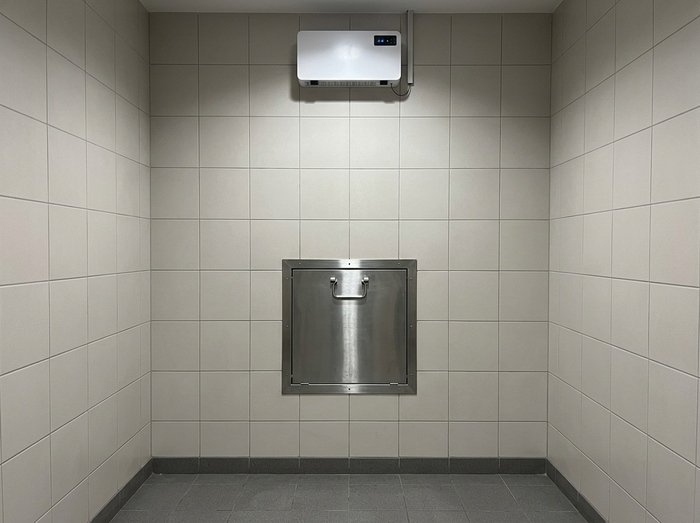 How to Choose a Garbage Room Odour Control System Wall-mounted air-treatment unit in a waste collection room